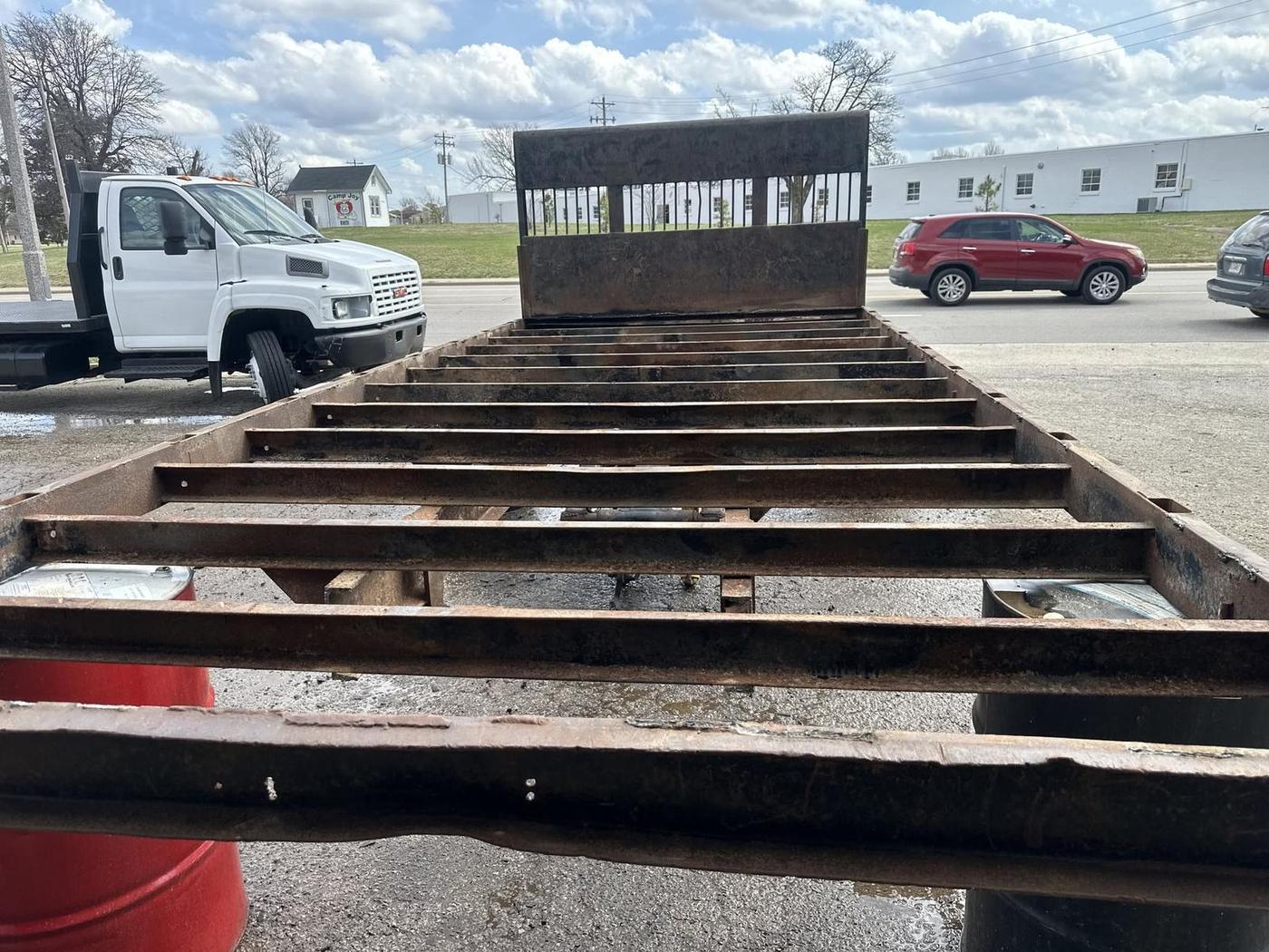 Bare steel truck bed frame in the yard during fabrication work